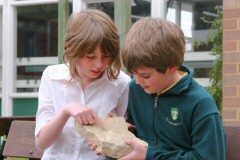 School children examining rock